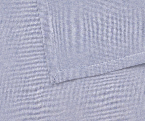 Elegant light blue table napkin styled with floral accents for a wedding tablescape.