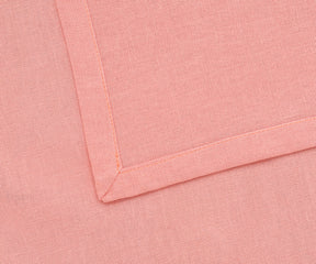 Reusable light pink cloth napkins styled with a floral centerpiece.