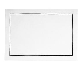 Black cotton placemats with white embroidered edges, perfect for dining table decor