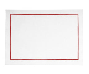 Elegant magenta table placemat with white plate and centerpiece decor on a wooden surface