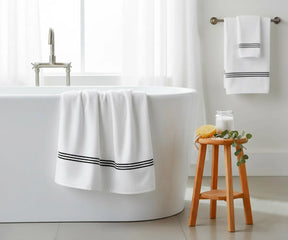 Premium striped cotton bath towel in white with black detailing, breathable and plush, available in multiple sizes for spa-quality luxury at home.