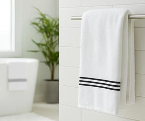Luxury black and white striped bath towel made from 100% premium cotton, featuring soft absorbent fabric with elegant black embroidery — perfect for home, spa, or gym use.