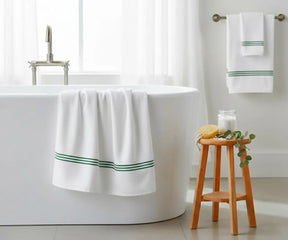 Soft white cotton bath towel with green stripe detailing, 30x58" (820 GSM), plush and quick-drying — premium towel for stylish and comfortable bathroom décor.