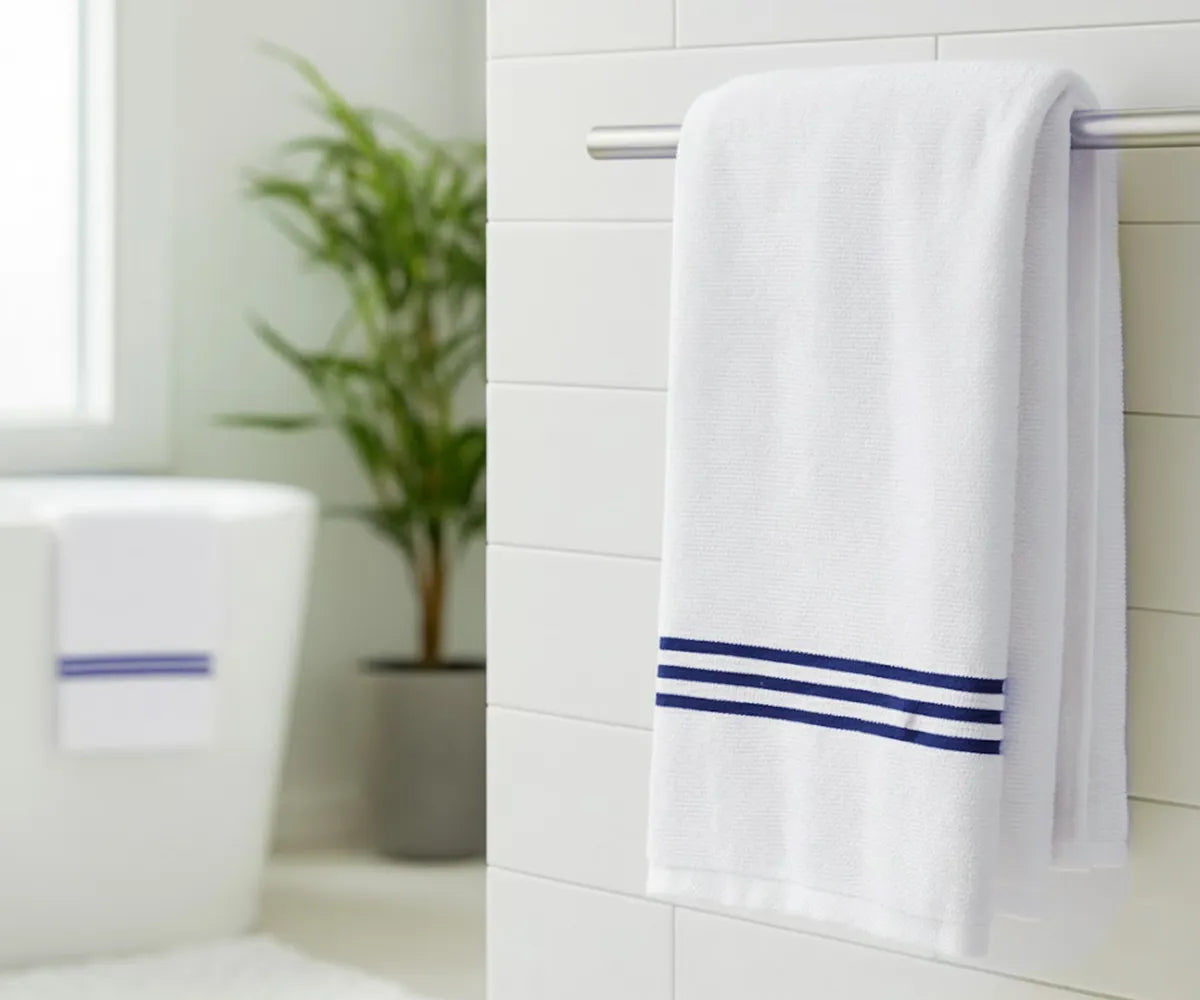 Luxury navy blue and white striped bath towel made from 100% premium cotton, featuring elegant navy embroidery for a soft, absorbent, and spa-quality experience at home.