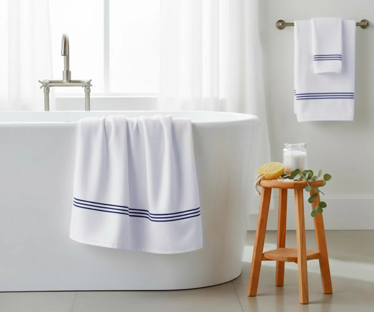 Soft white cotton bath towel with navy blue embroidered stripes, 30x58" (820 GSM), plush and quick-drying — perfect for a modern, stylish bathroom look.