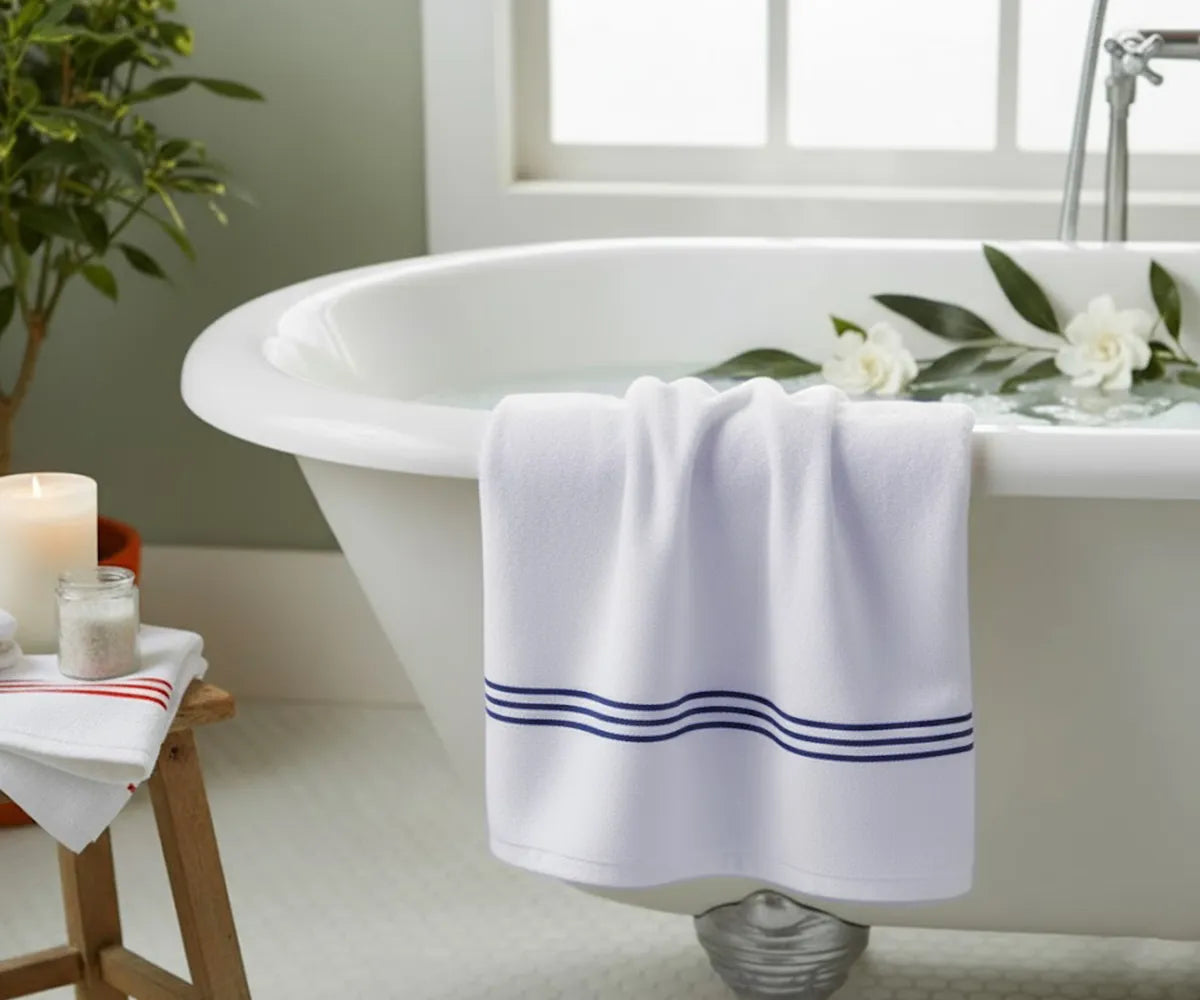 Elegant striped bath towel in crisp white with navy embroidery, breathable and luxurious, ideal for home, spa, or gym use — available in multiple sizes.