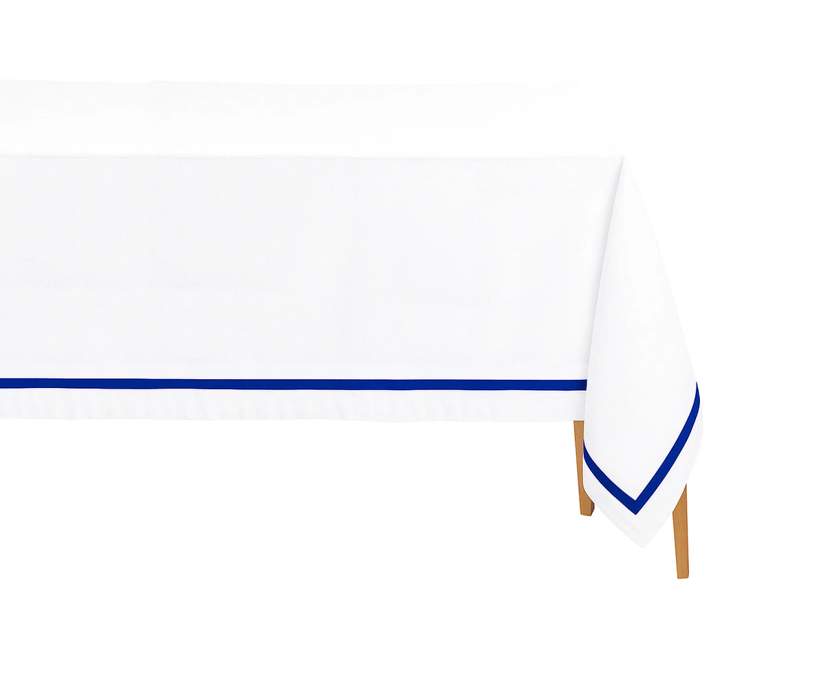 Royal blue satin border rectangle cotton tablecloth on a white dining table, perfect for weddings and special events.
