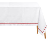 Magenta embroidered cotton rectangle tablecloth displayed on a dining table