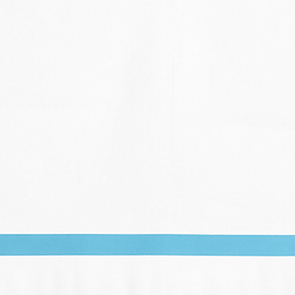 Close-up detail of white cotton pillowcase with a light blue border line.