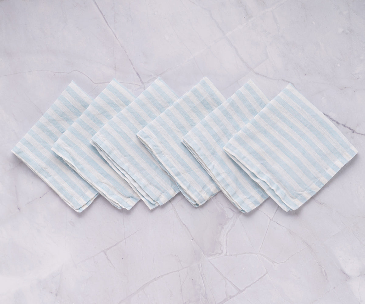 A neatly organized set of four striped linen napkins in blue and white