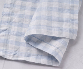 Blue and white checked linen napkin displayed on a white background