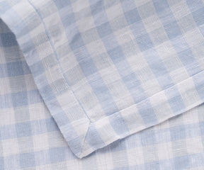 Detailed view of the blue and white checkered pattern on a linen napkin
