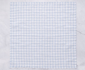 Elegant blue napkins, crafted from quality cloth, introduce a calming and refreshing element to your table setting.