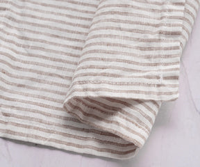 12x12 inch linen cocktail napkin folded neatly with a drink and snack