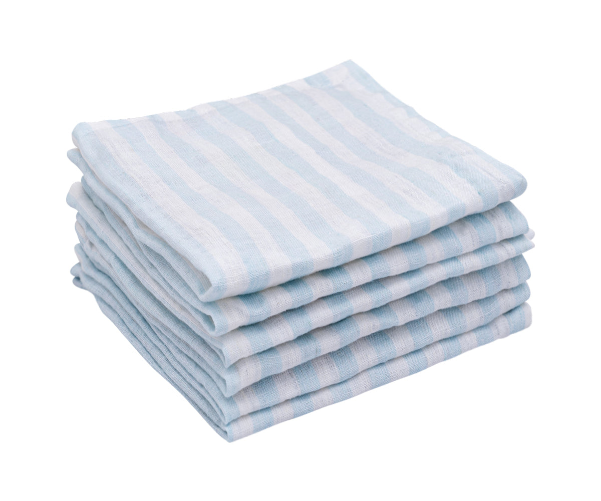 A tidy stack of blue and white striped linen napkins on display
