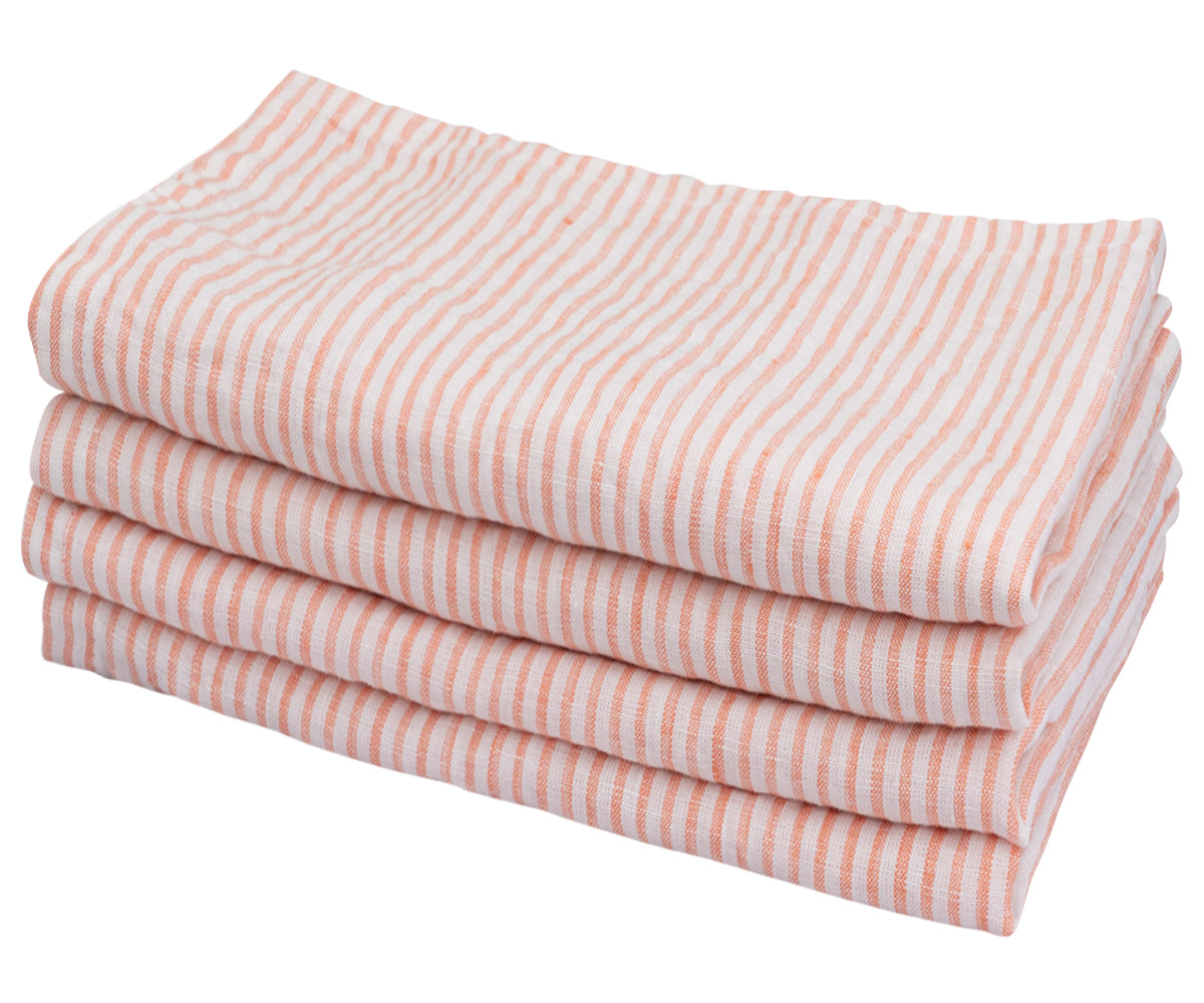 A neatly stacked set of pink and white linen striped napkins