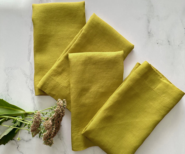 Bold yellow cloth napkin as part of a minimalist dining arrangement