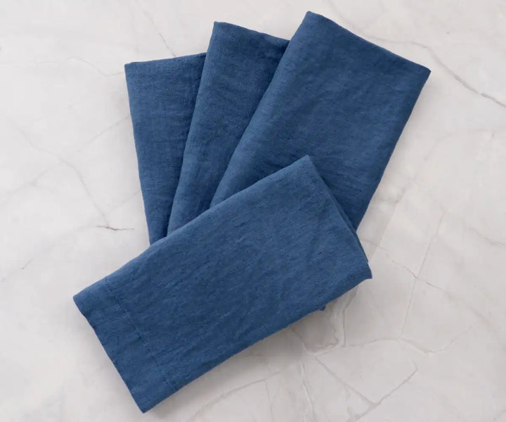 Home tableware set featuring four blue cloth napkins