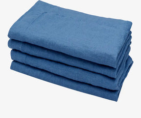 Four blue-colored linen napkins are presented in a folded arrangement, ready for use at a meal or gathering.