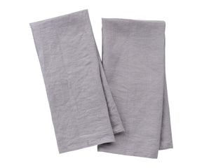 Natural gray linen tea towel draped over oven handle