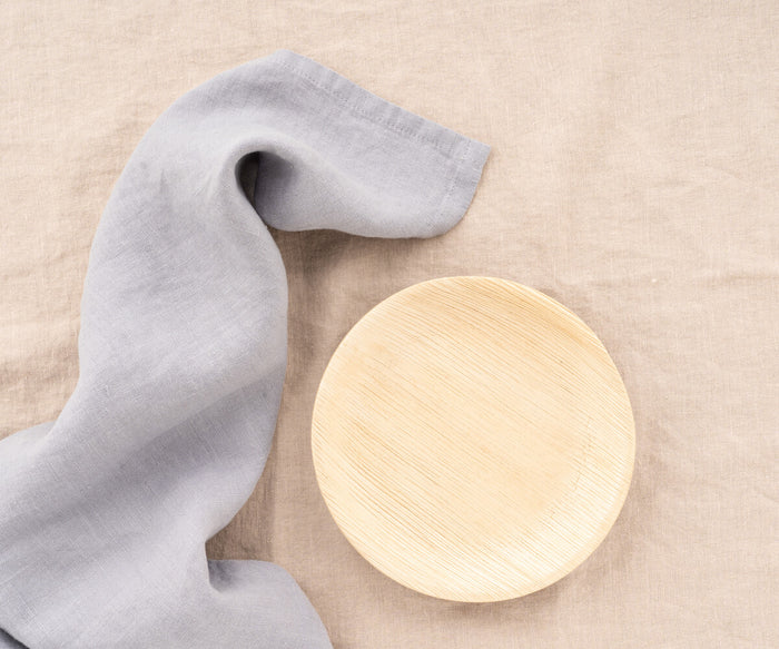 Gray linen kitchen towels folded on marble countertop