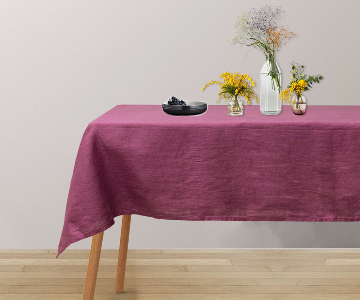 A rectangular tablecloth in classic linen material. Elegant dark pink tablecloth for a vibrant table setting.
