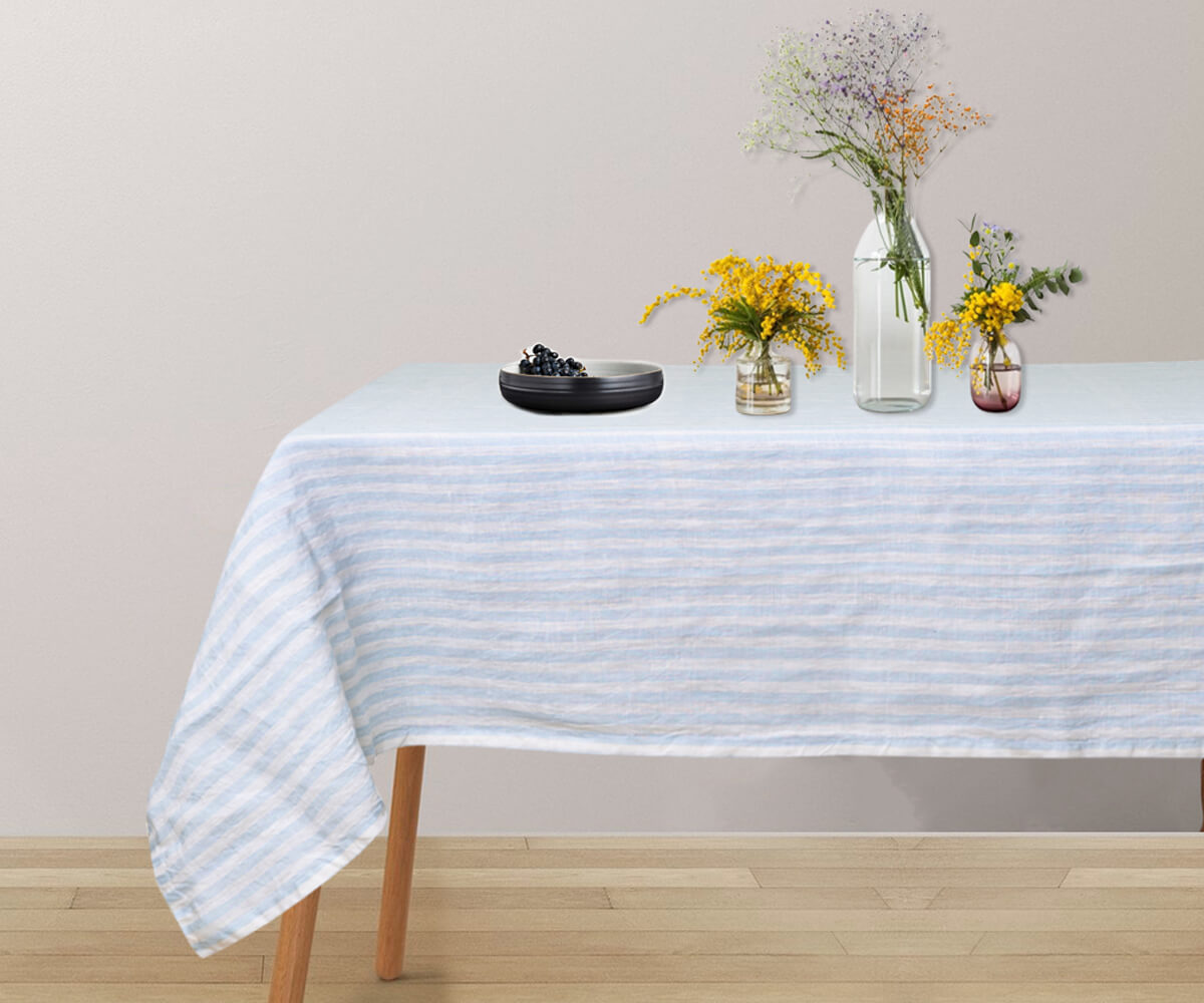 A rectangular linen tablecloth in classic linen material. Elegant blue tablecloth for a vibrant table setting.