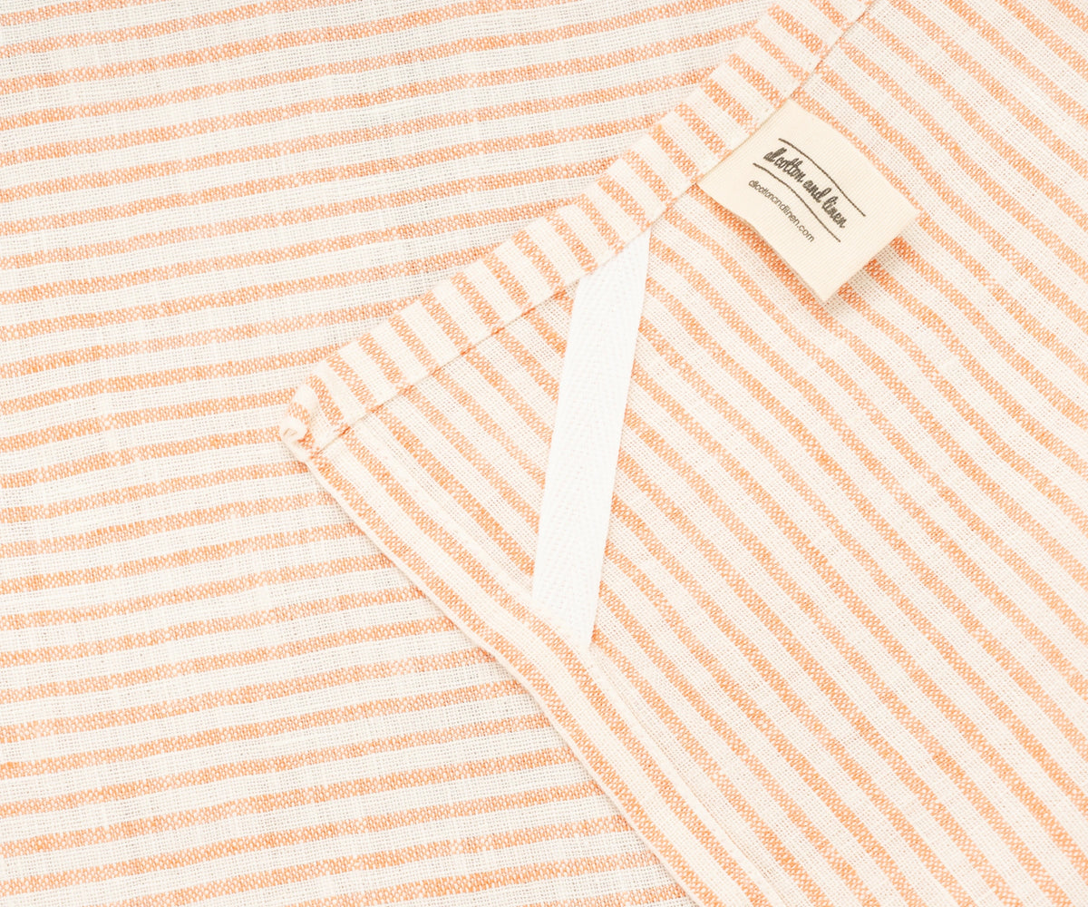 Close-up of bright orange stripes on 100% linen kitchen towel