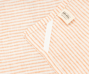 Close-up of bright orange stripes on 100% linen kitchen towel