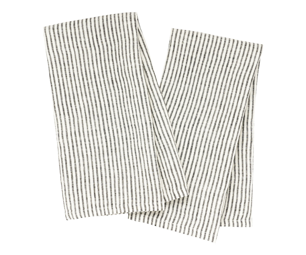 Eco-friendly linen dish towels laid out beside ceramic dishes