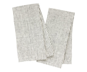 Eco-friendly linen dish towels laid out beside ceramic dishes