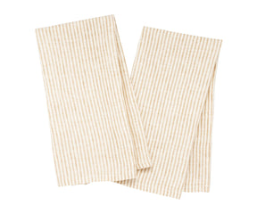 Rustic kitchen setting with natural stripe dish towels hanging on hooks