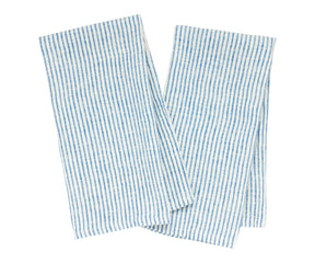 Blue striped kitchen towels hanging on rustic hooks in a farmhouse kitchen