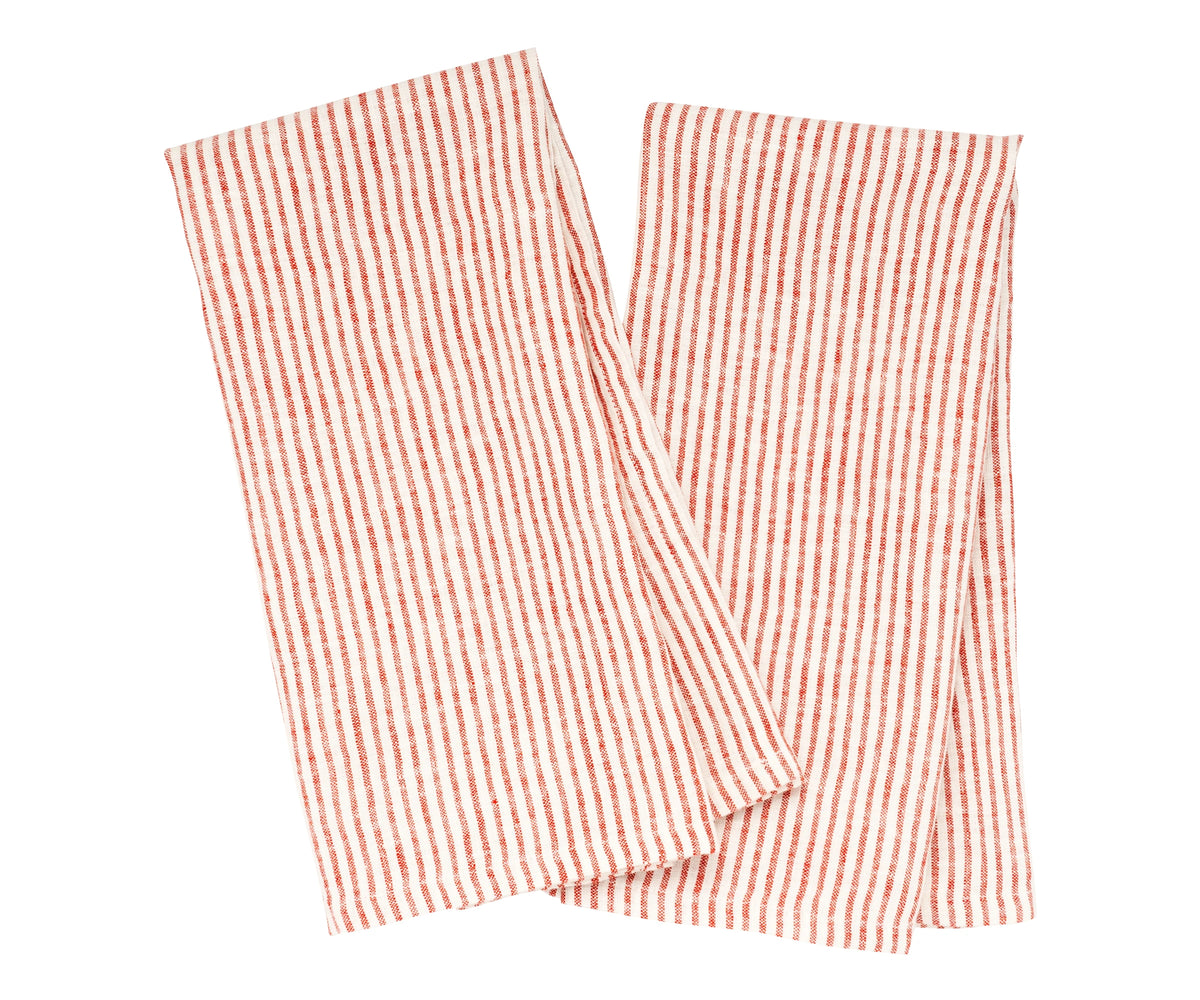 Red striped linen kitchen towel draped over a farmhouse sink