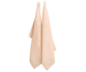 Set of 6 orange striped linen dish towels folded neatly on a rustic countertop