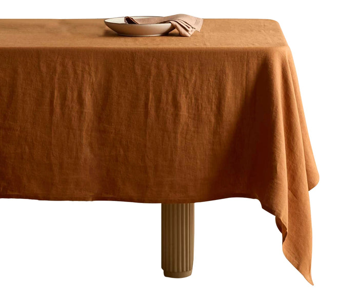 Plain tablecloth adding warm, earthy elegance to any dining table.