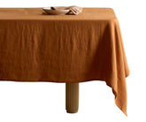 Plain tablecloth adding warm, earthy elegance to any dining table.