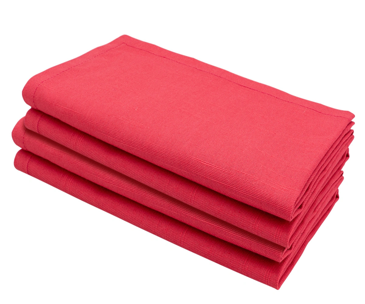 Set of maroon cloth napkins arranged beautifully for a festive dinner setting.