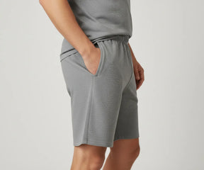 Grey cotton men’s shorts with practical side pockets, machine washable design for durable use during workouts or lounging