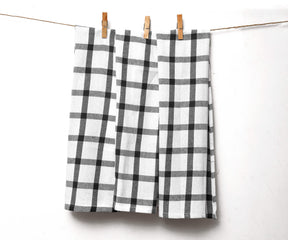Black and white plaid towel hanging outdoors on a washing line