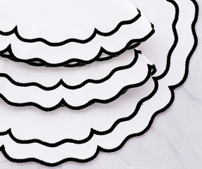 Neatly arranged black and white cloth placemats for elegant decor
