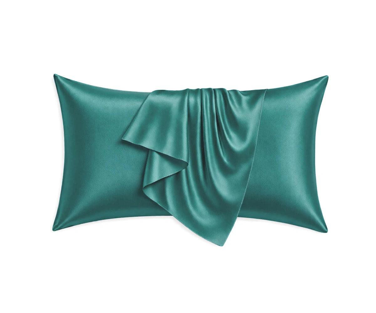 Teal mulberry silk pillowcases with a smooth, glossy sateen finish, offering breathable luxury and a cool, silky feel for beauty sleep.