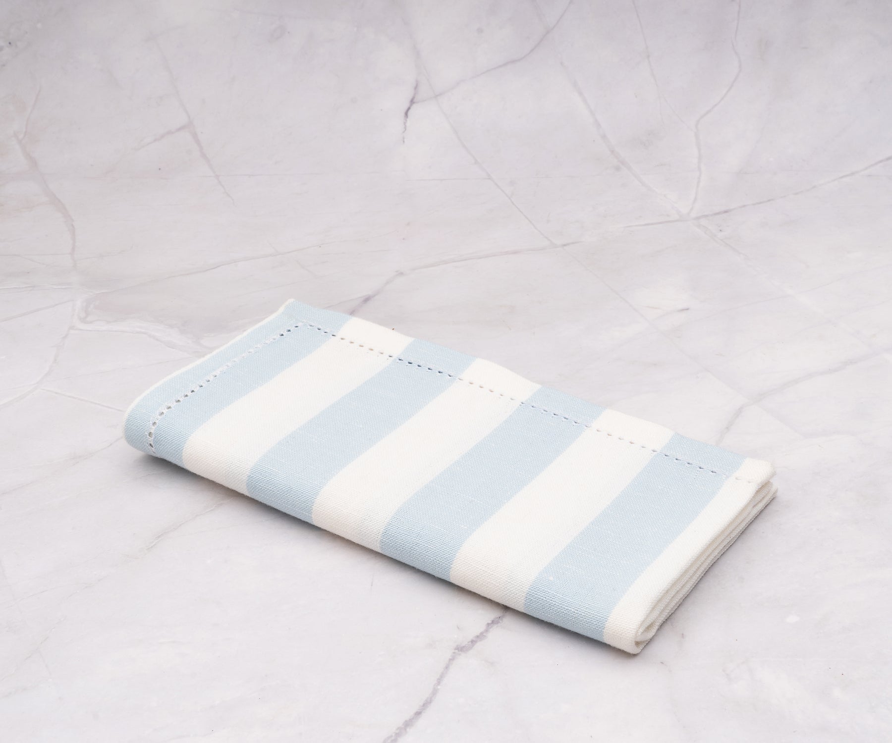 Machine-washable pale blue cotton napkins with classic cabana stripe pattern.
