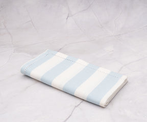 Machine-washable pale blue cotton napkins with classic cabana stripe pattern.
