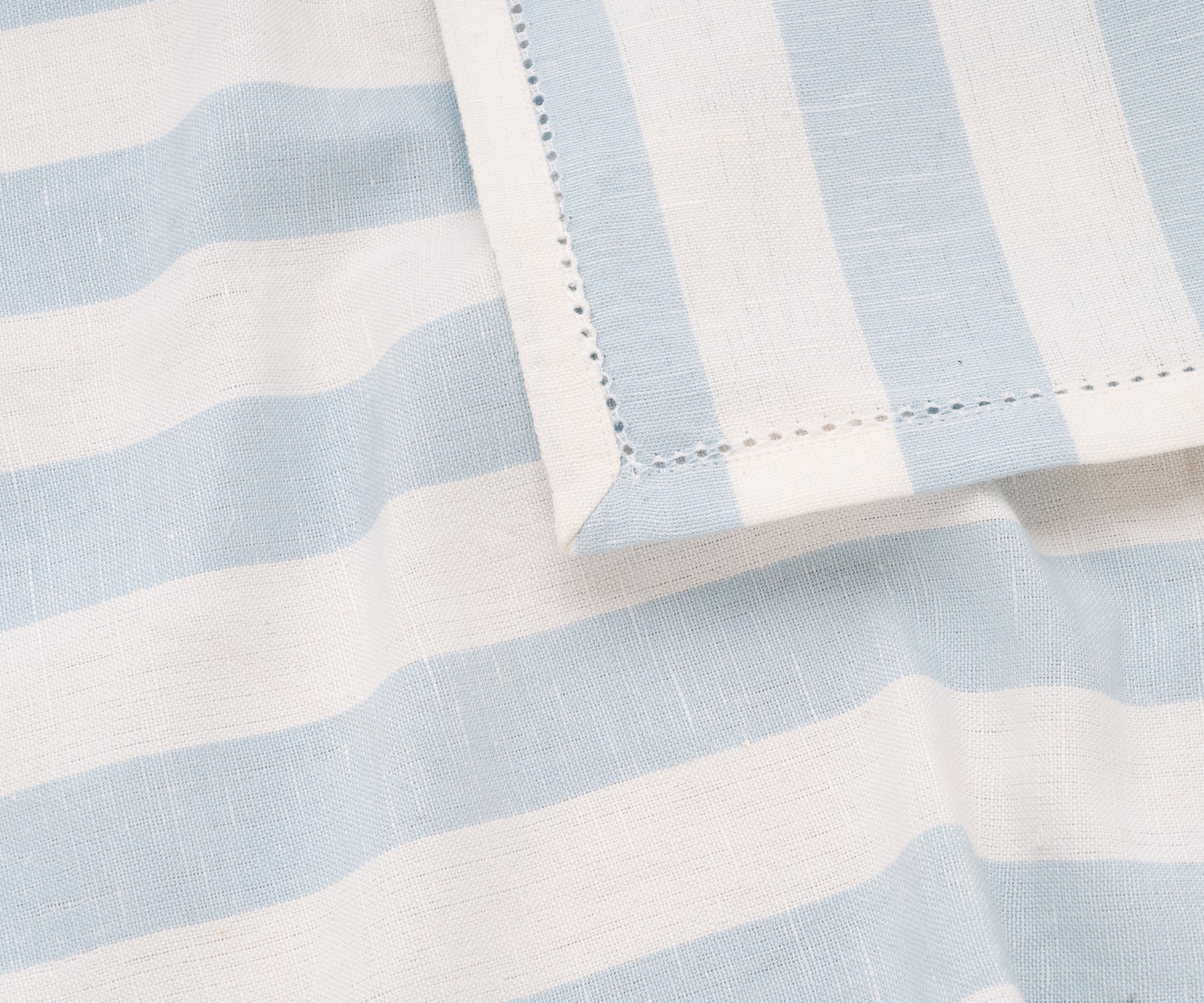 Luxury cotton pale blue napkins with cabana stripe, perfect for entertaining guests.
