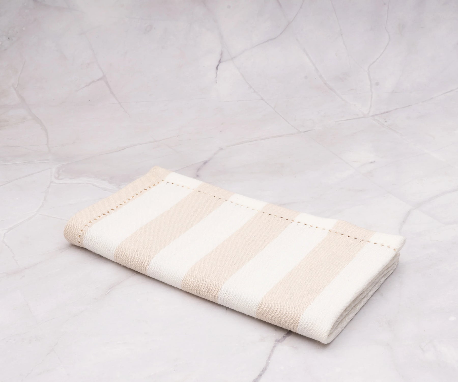 Durable beige cotton napkins with a subtle cabana stripe, perfect for brunch.
