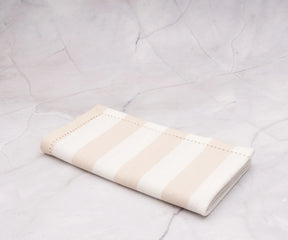 Durable beige cotton napkins with a subtle cabana stripe, perfect for brunch.
