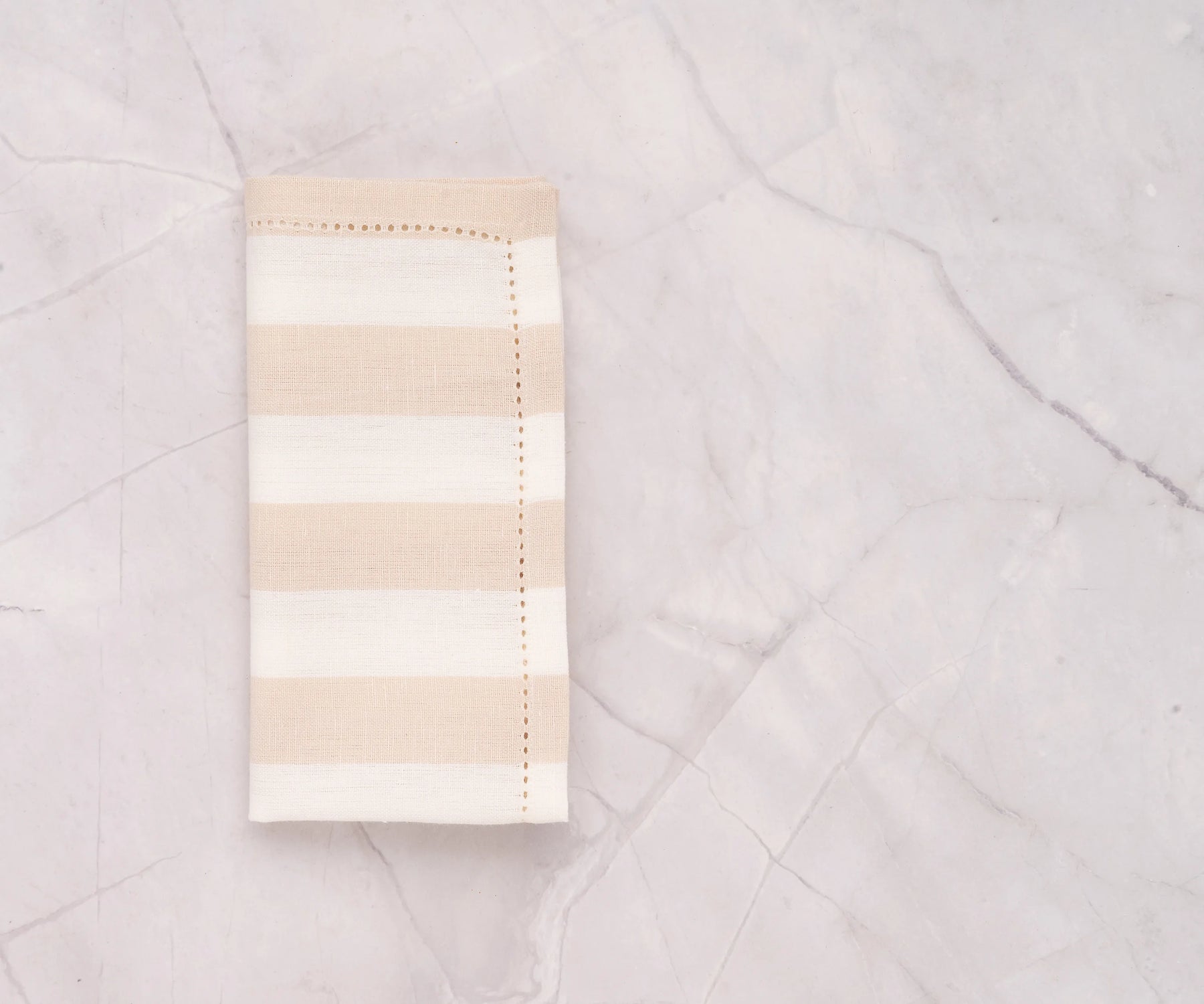 Luxury cotton beige napkins with cabana stripe, perfect for entertaining guests.
