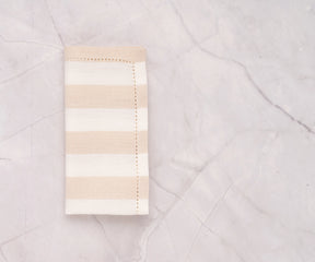 Luxury cotton beige napkins with cabana stripe, perfect for entertaining guests.

