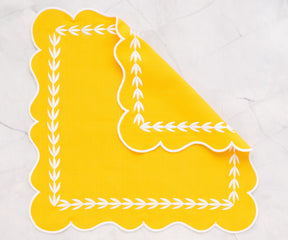 Yellow scalloped napkins in 100% cotton, available in 18x18, 20x20, and 22x22 inch sizes, perfect for everyday meals and special occasions